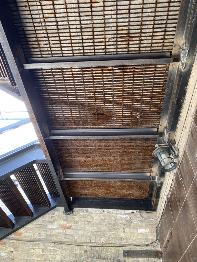 Improvements of supporting structure play important role in stability of grate steel. Placement of steel channels under the grated steel panels where there is a small gap between them improves stability of the whole deck. These 3 channels going along the span of the deck will improve rigidity of these panels. JW Investrade Inc. for metalgrating.ca 2021, London, Ontario.