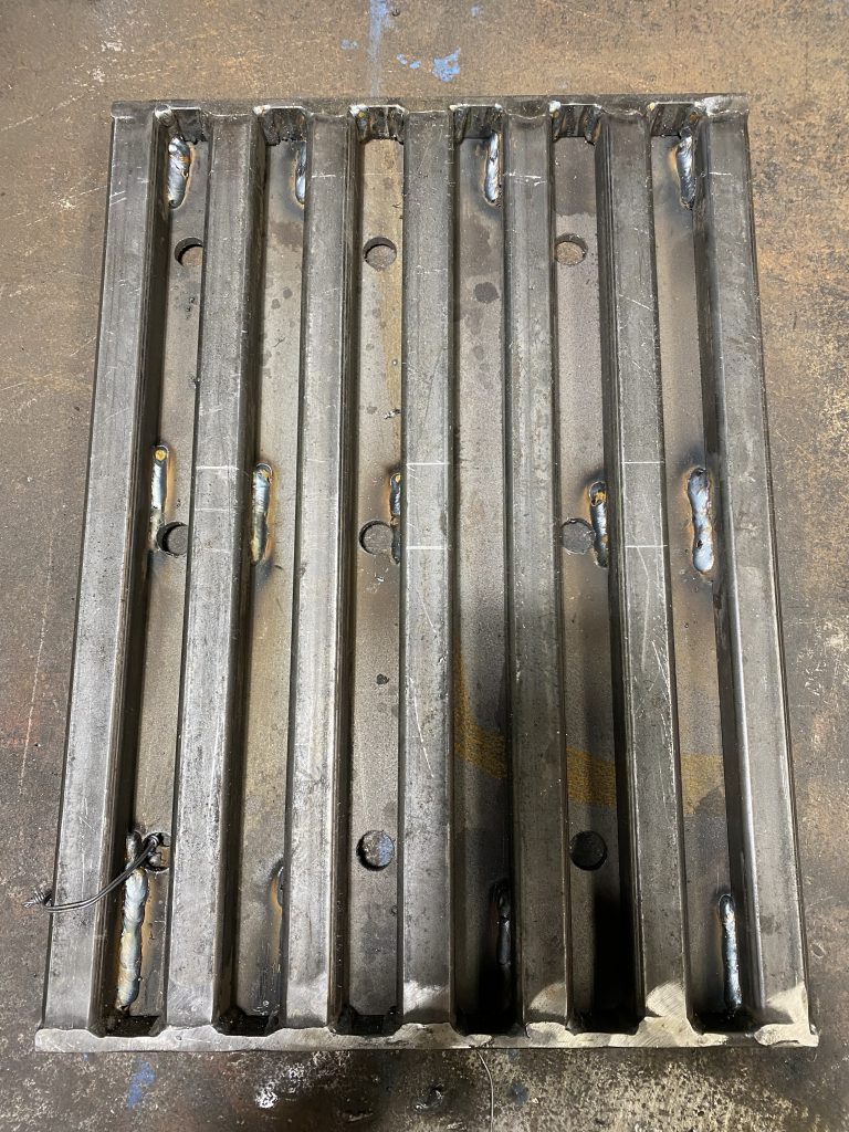 The supporting structure of bearing tubes is welded to 2 heavy banding bars and forms complete tube grating. The heavy plate does not extend past the tube grating that is why this floor drain cover requires steel angle support in the drain to be installed properly.