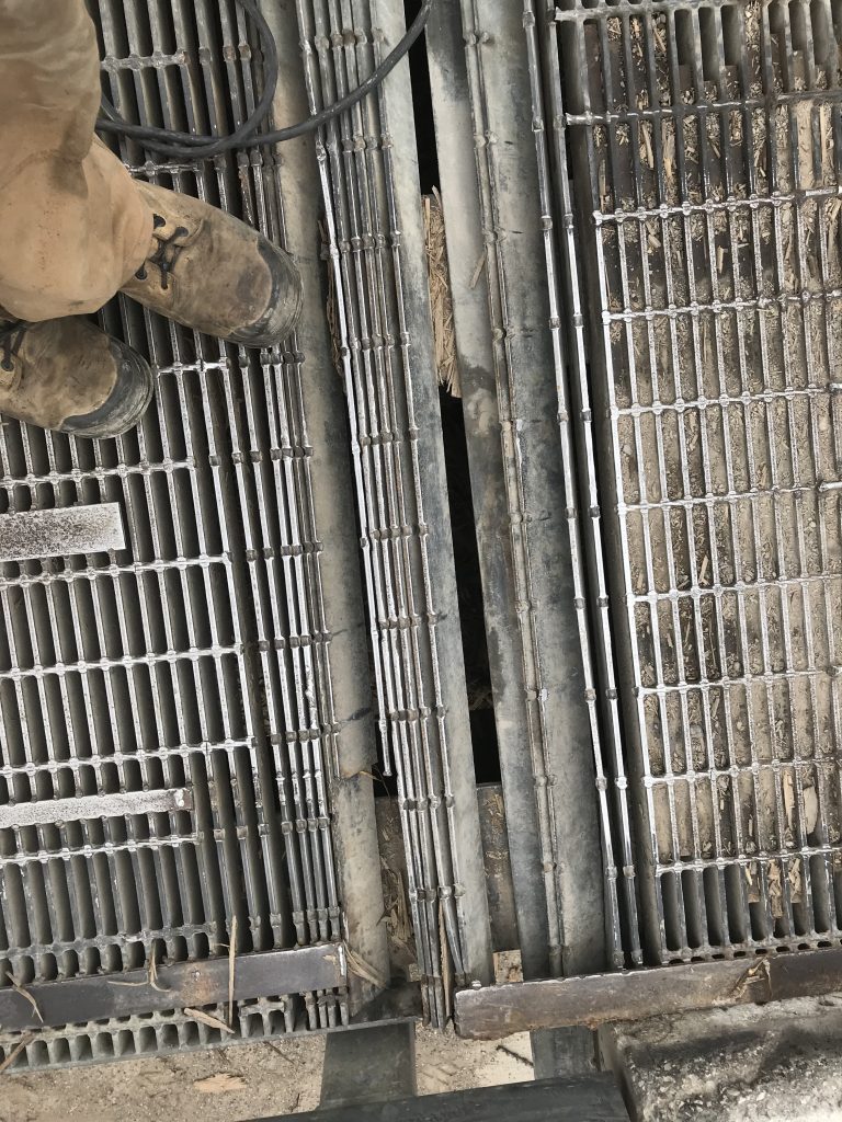 A massive damage to two metal grates' panels consisting of 11 twisted bearing bars including 2 bars with missing ends and 6 bearing bars with missing cross bars. This is just emergency repair since these 2 panels should be replaced ASAP. JW Investrade Inc for metalgrating.ca 2018 Strathroy Ontario.