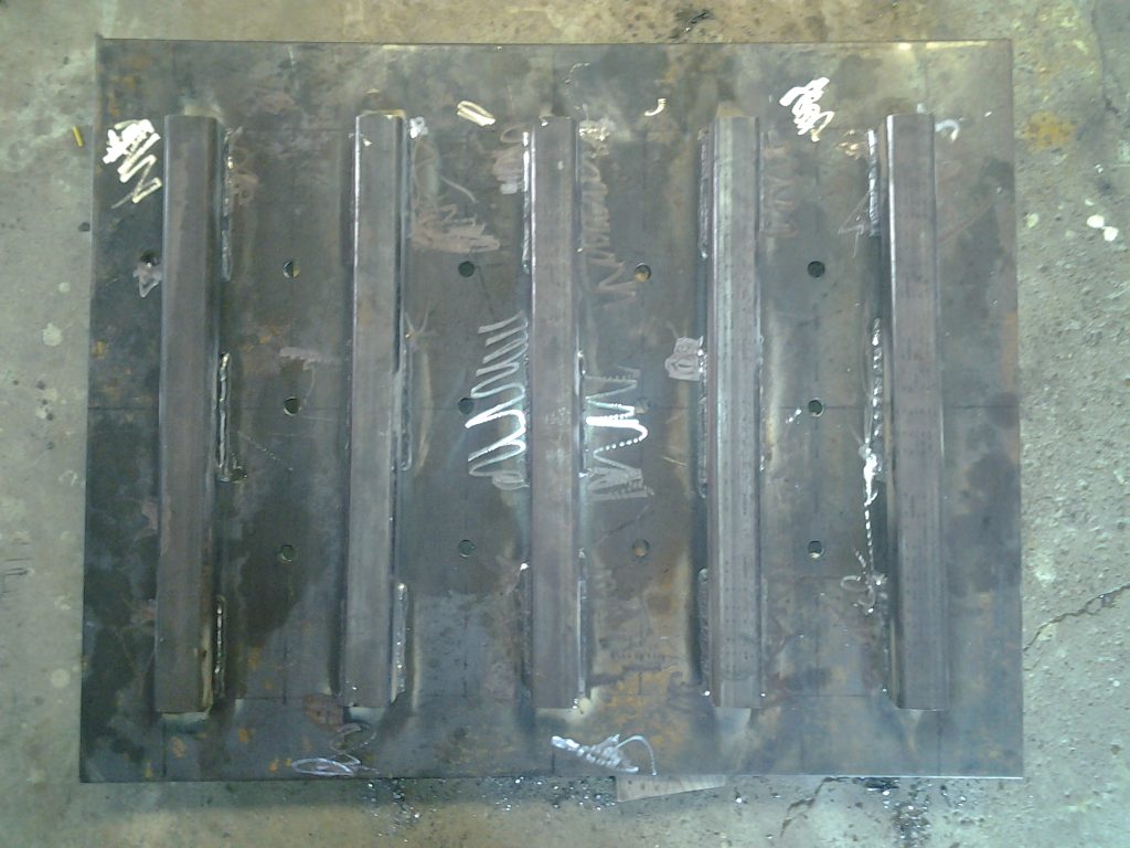 Fabricated drain cover for the large warehouse does not have a full bearing tube grating support. The weldment must sustain heavy forklift operations. JW Investrade Inc. for metalgrating.ca 2016 London, Ontario