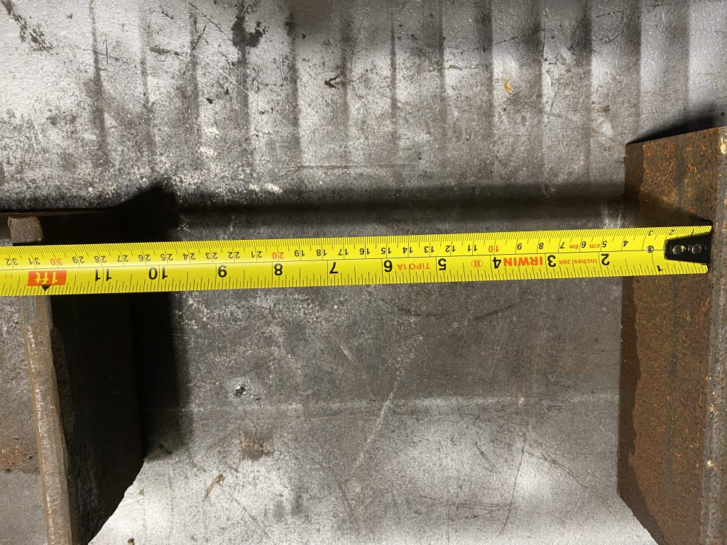 Inside measurement between two heavy angles. The distance is about 1 foot or about 30.2 cm. Please note that the hook is attached to steel only by the force of magnets in the hook and the tape measure must be pushed for more accurate measurement. JW Investrade Inc. for metalgrating.ca 2023 London Ontario