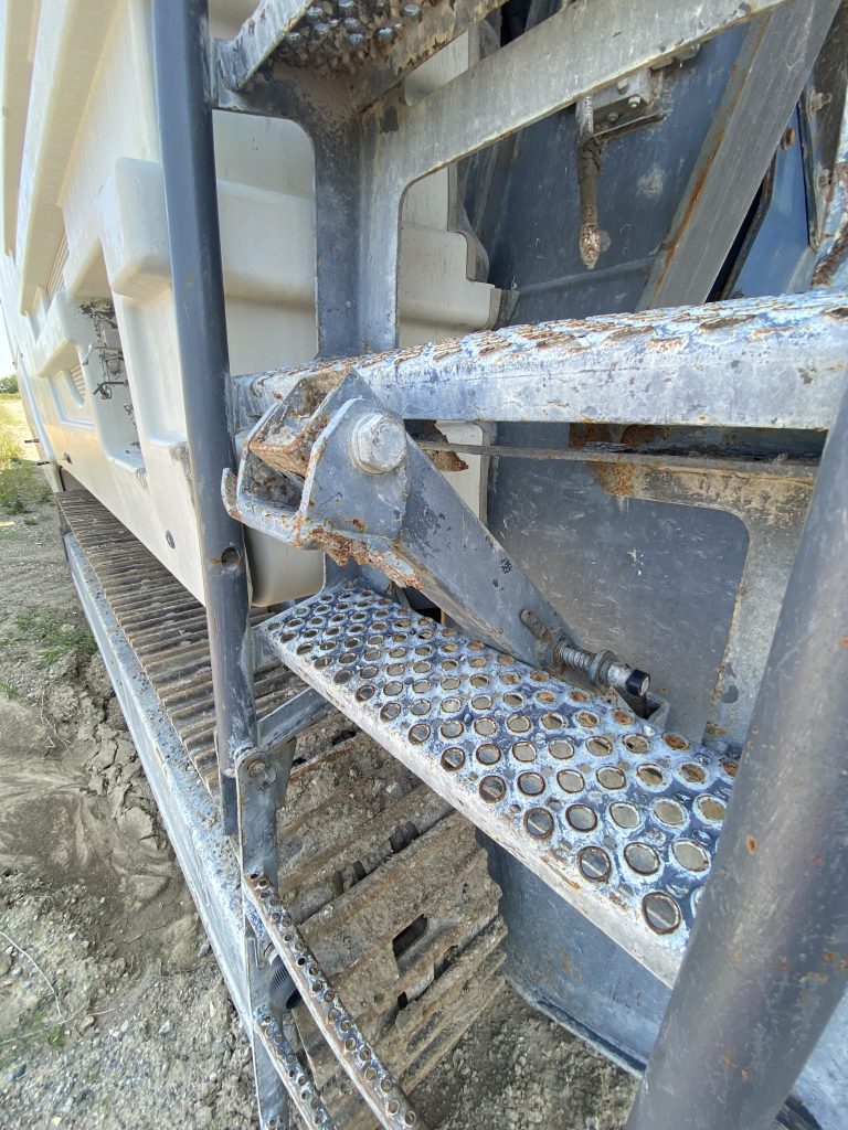 Here us the example of galvanized perforated grating used as a step in a ladder for heavy equipment. Please notice the raised perforations that increase traction for workers muddy boots. JW Investrade Inc. for metalgrating.ca 2023, London, Ontario