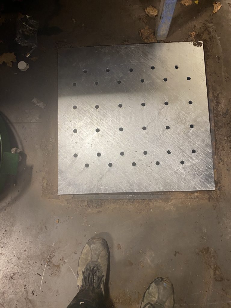 The new 12 bearing tube's floor drain cover has replaced the old and damaged drain cover. Now the 0.38 thick plate and the heavy tube supporting structure will carry the load of this shelf. JW Investrade Inc for metalgrating.ca 2023, London, Ontario