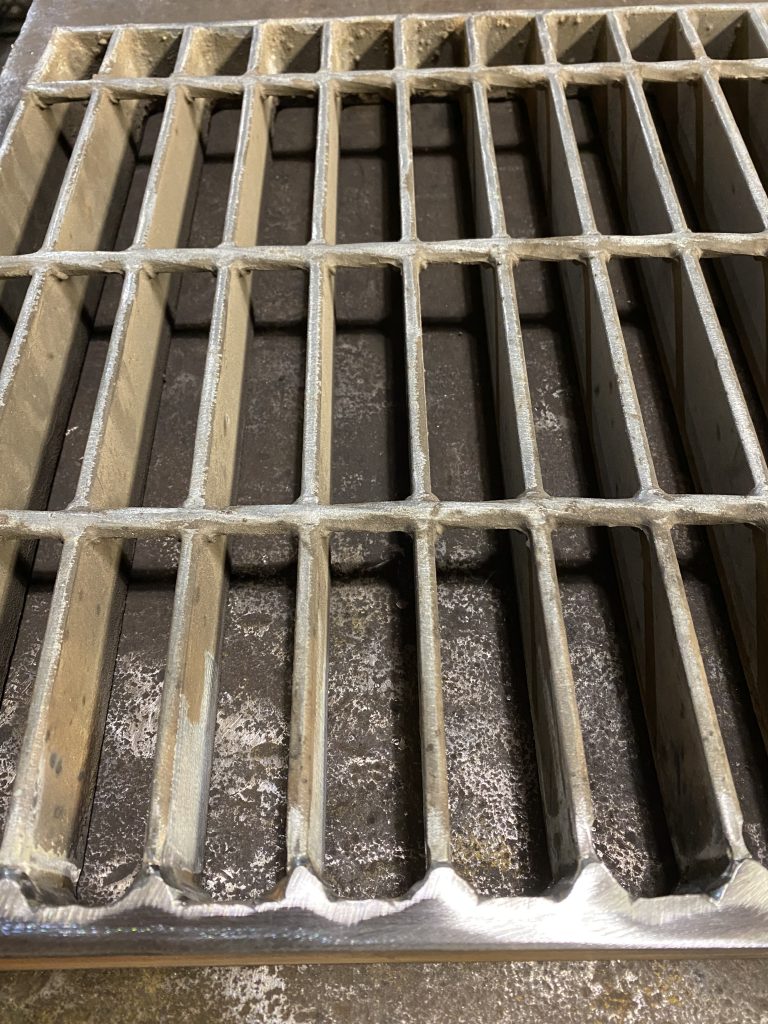 We are able to weld in thick banding to old steel metal grates as long as they are not damaged structurally, Here is the improved thick banding bar with our antivibration welds in old grates steel panel. Please notice, we had to remove galvanization from small portion of bearing bars where we welded banding bar. The old steel metal grate panel with improved banding. JW Investrade Inc. for metalgrating.ca 2023, London, Ontario.