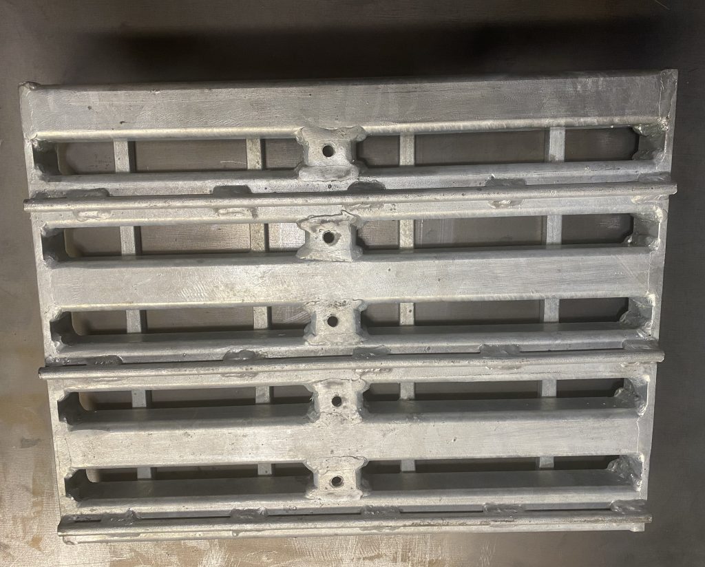 We are using 2 x 2 x 0.250 hollow square tubes, bearing tubes, as a main structural element for building our steel metal grating weldment panel due to their grater resistance to impact and load damages in comparison to 2 x 1/4 inch bearing bars of the same size. The short spacer tubes, cross tubes, that are welded to bearing tubes are drilled for internal wall galvanization. JW Investrade Inc. for metalgrating.ca 2023, London, Ontario.