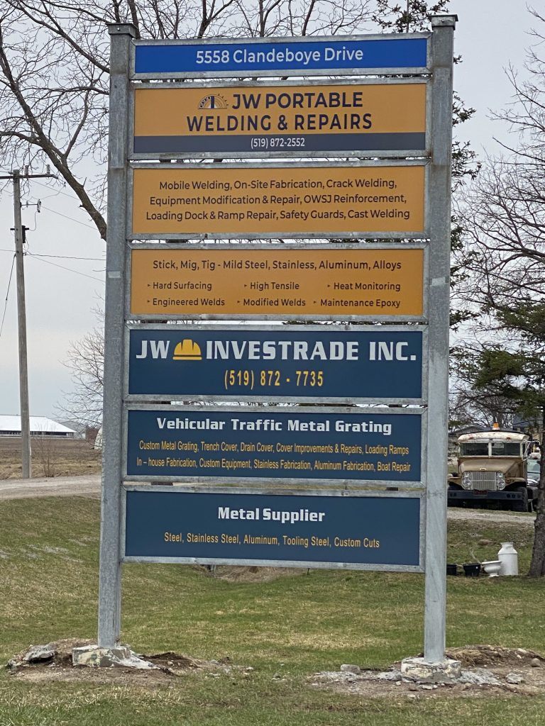 The large commercial signs provides the address for welding shop of JW Portable Welding & Repairs and JW Investrade Inc. The sign also lists services or products provided by these two companies along with companies' names, logos and phone numbers.