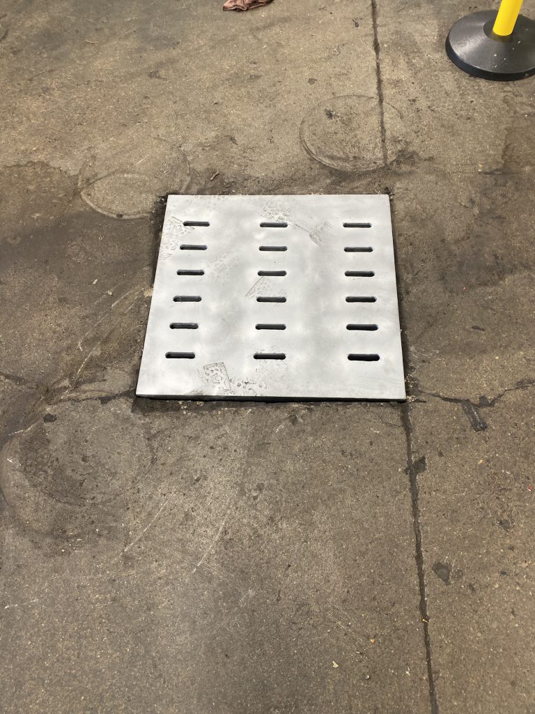 Heavy duty supported style lid for semitruck vehicular traffic with depth of 3" and slots for better drainage. The lid has been installed in busy heavy truck repair shop in place where trucks are turning and stopping. There is some dynamic loads acting on the lid. For JW Investrade Inc. www.metalgrating.ca, London, Ontario, 2024